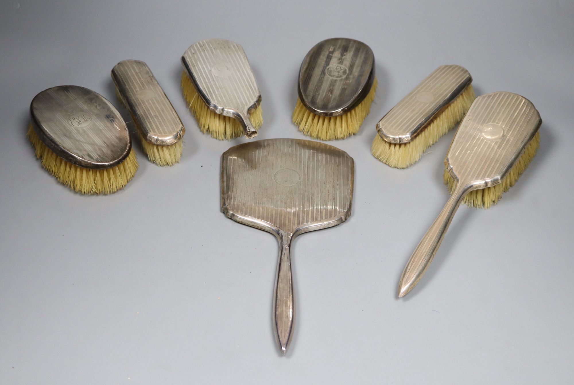 Seven various silver mounted hair and clothes brushes, one a.f.